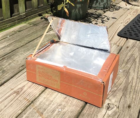 heating a metal black box solar oven|how to use a solar oven.